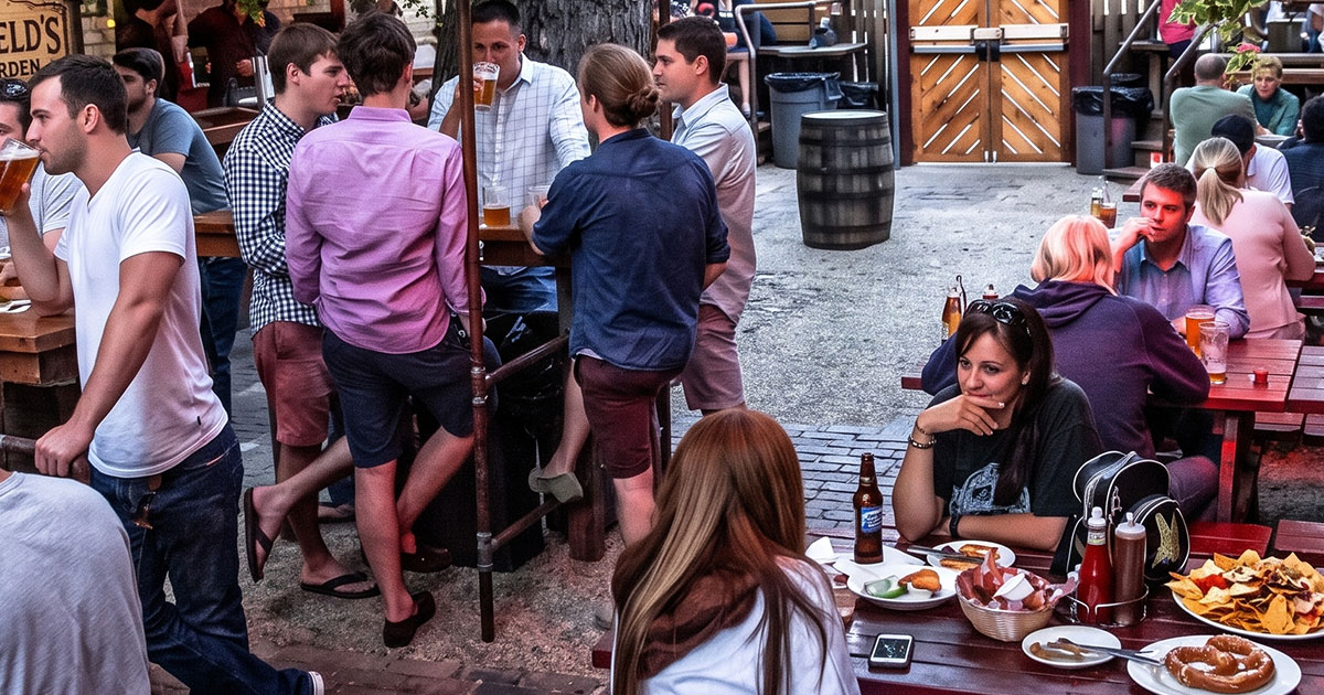 Busy Wrigleyville bar patio full of people on a warm afternoon