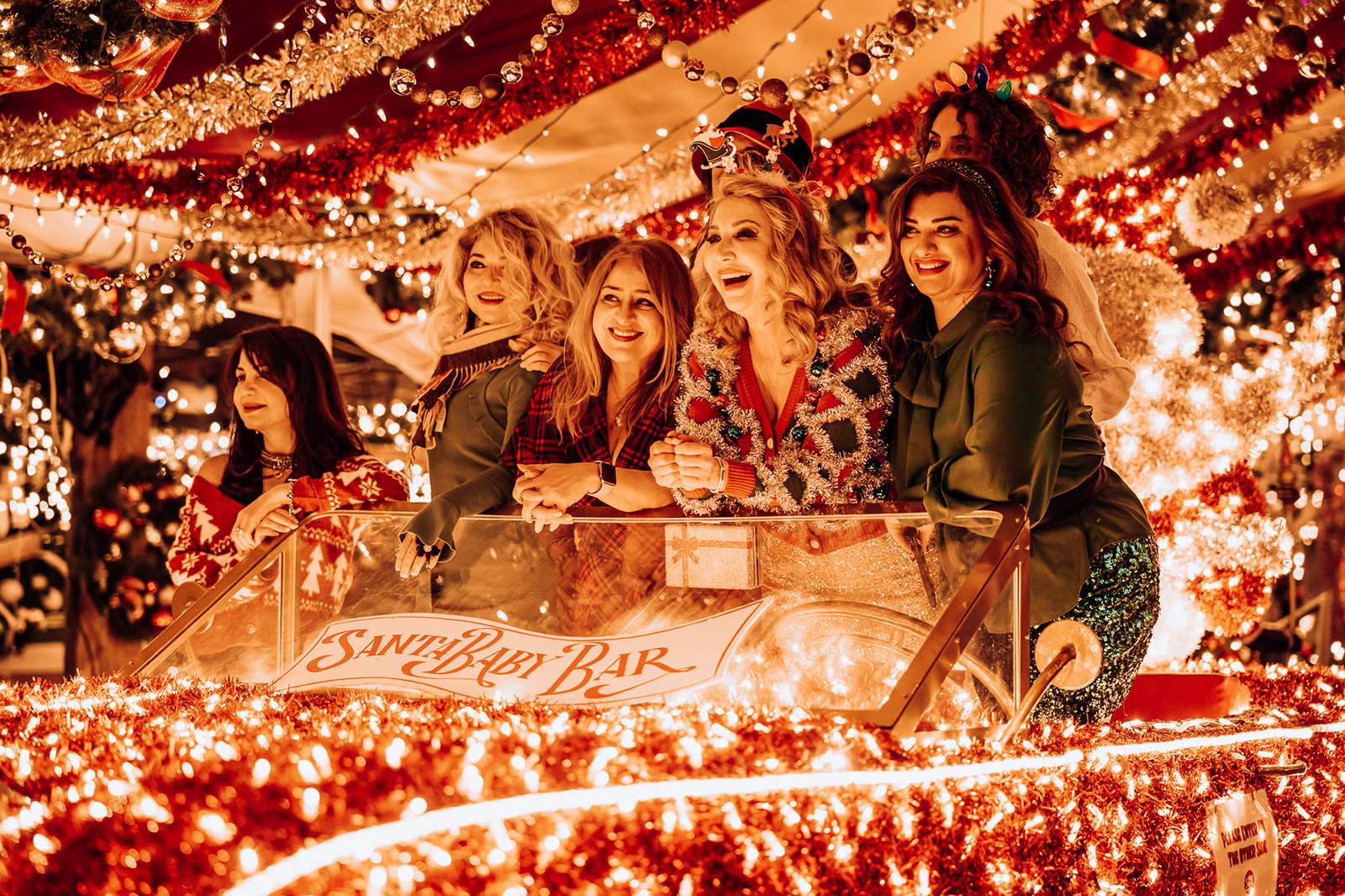 Friends celebrating under holiday lights at a Wrigleyville bar
